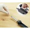 A gloved hand holds a component near a soldering iron. Produktbild-Vorschau