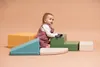 A baby playing on colorful foam climbing blocks. Anteprima dell’immagine prodotto