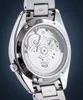 Close-up view of the back of a silver automatic watch with a transparent case back showing the internal movement. Produktbild-Vorschau