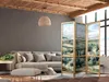 A living room scene with a sofa, ottoman, and a decorative room divider. Produktbild-Vorschau