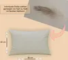A light beige pillow is shown with dimensions indicated, and a feather is visible in the background. Produktbild-Vorschau