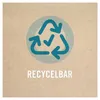 A recycling symbol with a checkmark inside, on a light brown background, with the text "RECYCELBAR" below it. Náhled obrázku produktu