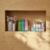 Various bathroom and personal care items organized in a built-in wall shelf. Produktbild-Vorschau