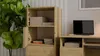 A wooden cabinet with open doors, showing stacked items inside, next to a desk with a laptop. Voir les images du produit
