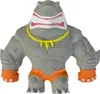 A toy shark figure with muscular arms and legs, wearing orange shorts and a yellow necklace. Náhľad obrázku produktu