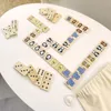 A collection of wooden dominoes with animal illustrations arranged on a white surface. Produktbild-Vorschau
