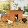 A wooden chicken coop with several chickens in a garden setting. Podgląd zdjęcia produktu