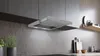 A modern kitchen with a sleek range hood installed above a countertop. Náhled obrázku produktu