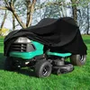 A lawnmower covered with a black tarp in a grassy yard with trees in the background. Produktbild-Vorschau