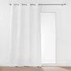 A white curtain hangs on a curtain rod in front of a glass door. Produktbild-Vorschau