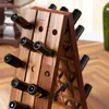 A wooden wine rack filled with wine bottles in a room. Produktbild-Vorschau