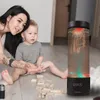 A woman and a child are playing with wooden blocks on the floor, with a jellyfish lamp in the background. Anteprima dell’immagine prodotto