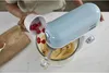 A person is adding raspberries to a stand mixer while baking. Produktbild-Vorschau