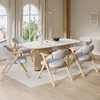 A dining room scene with a table and chairs. Voir les images du produit