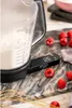 A close-up of a digital kitchen scale with a clear measuring jug filled with white powder, placed on a marble countertop with raspberries scattered around. Náhľad obrázku produktu