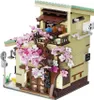 A detailed model of a Japanese-style building with cherry blossoms. Produktbild-Vorschau