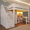A white loft bed with integrated desk, shelves, and wardrobe, set in a child's bedroom. Voir les images du produit