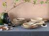 A table setting with plates, bowls, cutlery, candles, and a vase with branches. Náhľad obrázku produktu