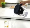 A hand is pouring water from a filter pitcher into a glass on a kitchen counter. Podgląd zdjęcia produktu