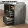 A close-up view of a gray wooden desk with two open drawers, revealing books inside. The desk is part of a home office setup. Produktbild-Vorschau