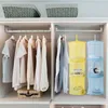 A closet interior with hanging clothes and storage organizers. Produktbild-Vorschau