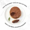 A close-up of cat food pâté on a white plate, with a sprig of rosemary and a small piece of the pâté beside it. Text overlays describe the product. Podgląd zdjęcia produktu