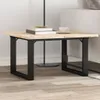 A close-up shot of a wooden coffee table with black metal legs, placed on a wooden floor. Podgląd zdjęcia produktu