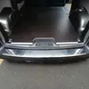 The rear interior of a vehicle, specifically the cargo area, with a protective mat and bumper protector installed. Produktbild-Vorschau