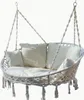 A white double hanging chair with cushions, suspended by ropes. Produktbild-Vorschau