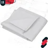 A white woven polypropylene bag is folded and placed on top of a blueprint or architectural drawing. Náhled obrázku produktu