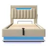 A beige upholstered bed frame with a slatted mattress support and blue LED lighting around the base and headboard. Náhled obrázku produktu