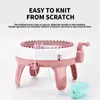 A pink and white knitting machine with a ball of mint green yarn. Náhled obrázku produktu