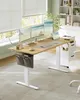 A modern home office setup with an adjustable desk, multiple monitors, and a chair, bathed in natural light from a window with blinds. Náhled obrázku produktu
