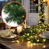 A decorated table setting with a Christmas garland and lights. Anteprima dell’immagine prodotto