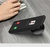 A hand is reaching for a smartphone that is displaying an incoming call screen, resting on a wooden surface. Produktbild-Vorschau