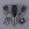 A hair clipper and its attachments are laid out on a gray surface. Podgląd zdjęcia produktu