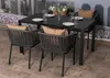 An outdoor dining set with a table and chairs on a tiled patio. Produktbild-Vorschau