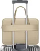 A beige laptop bag is attached to the handle of a silver suitcase. Náhľad obrázku produktu