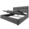 A grey upholstered bed frame with the mattress support mechanism lifted to reveal the storage space underneath. Produktbild-Vorschau