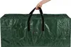 A hand holding the handles of a large, dark green storage bag. Produktbild-Vorschau