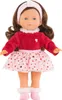 A doll with brown hair and blue eyes, wearing a red top and a pink skirt with hearts, standing against a white background. Produktbild-Vorschau