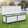 An outdoor storage box is placed on a green lawn in front of a modern house with a swimming pool. Anteprima dell’immagine prodotto