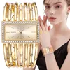 A woman is wearing a gold-colored watch with rhinestones. Produktbild-Vorschau