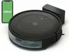 A black iRobot robotic vacuum cleaner is shown with its charging dock and a smartphone displaying the iRobot app. Podgląd zdjęcia produktu