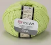 A ball of light green yarn with a label wrapped around it. Podgląd zdjęcia produktu