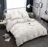 A bedroom scene with a bed made with floral patterned bedding. Náhled obrázku produktu