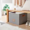 A storage box is placed under a wooden bench, with a plant and shoes nearby. Náhled obrázku produktu