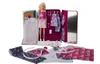 A Barbie doll is shown with a fashion salon playset, including clothes, patterns, and accessories. Produktbild-Vorschau