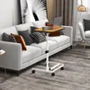 A laptop table is placed next to a sofa in a living room. Anteprima dell’immagine prodotto