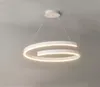 A modern white LED pendant light with a spiral design, suspended from the ceiling. Produktbild-Vorschau
